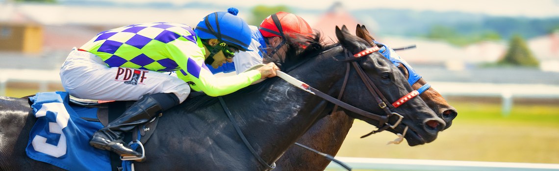 Two horses and jockeys in a close race