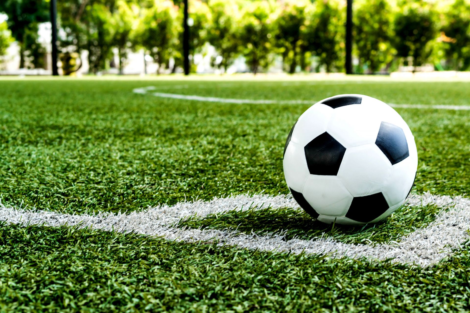 Black and white football placed in corner of pitch
