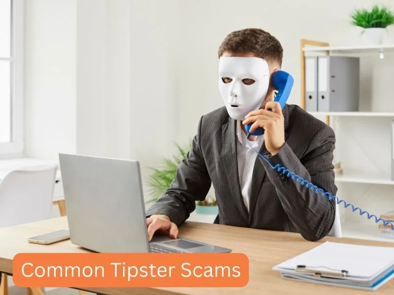 Man sitting at desk with white mask on talking on phone