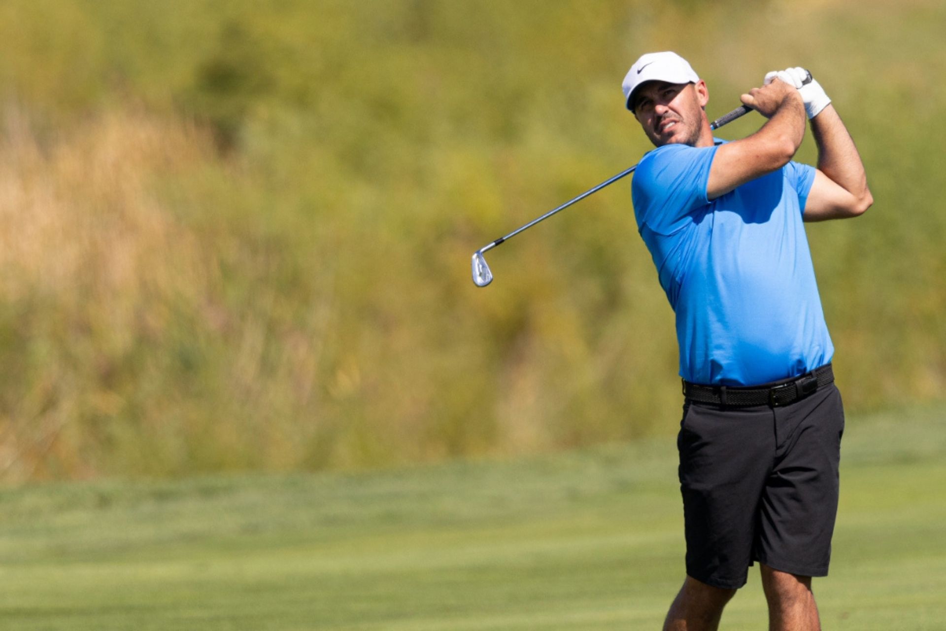 Golfer teeing off on a sunny course – featured image for Golf Betting Club review